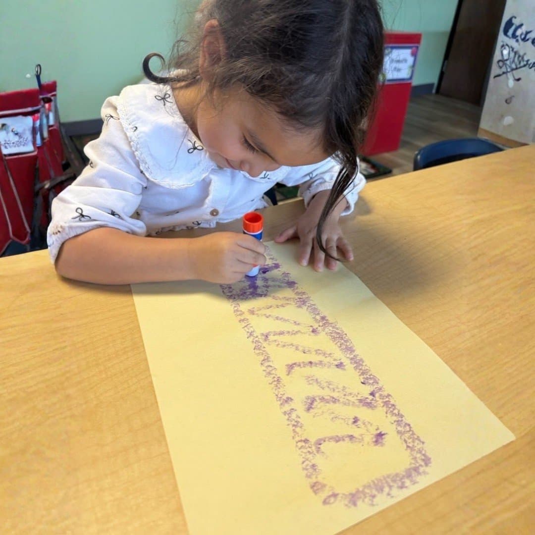 Student working on a glue-stick craft project