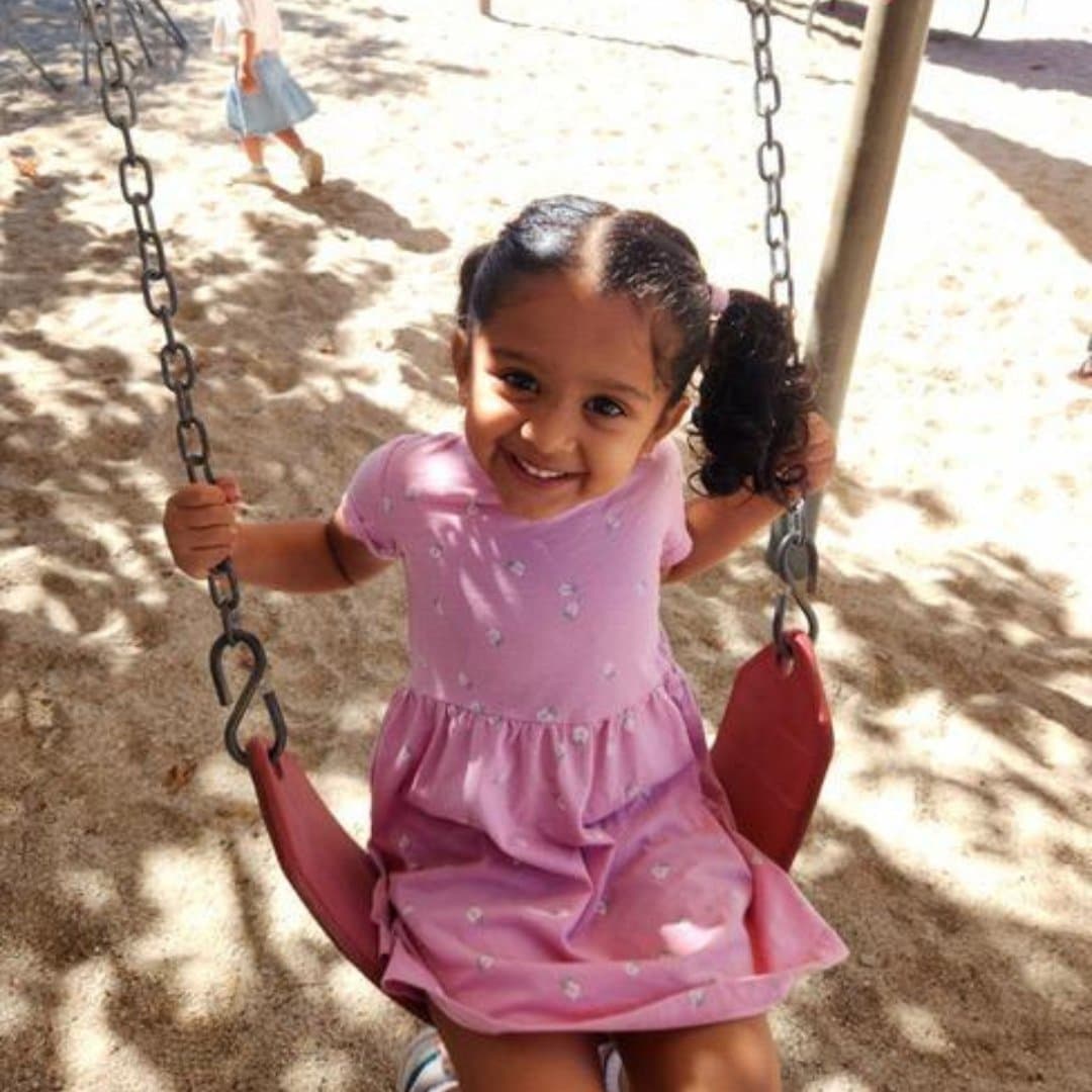 Student swinging on the playground