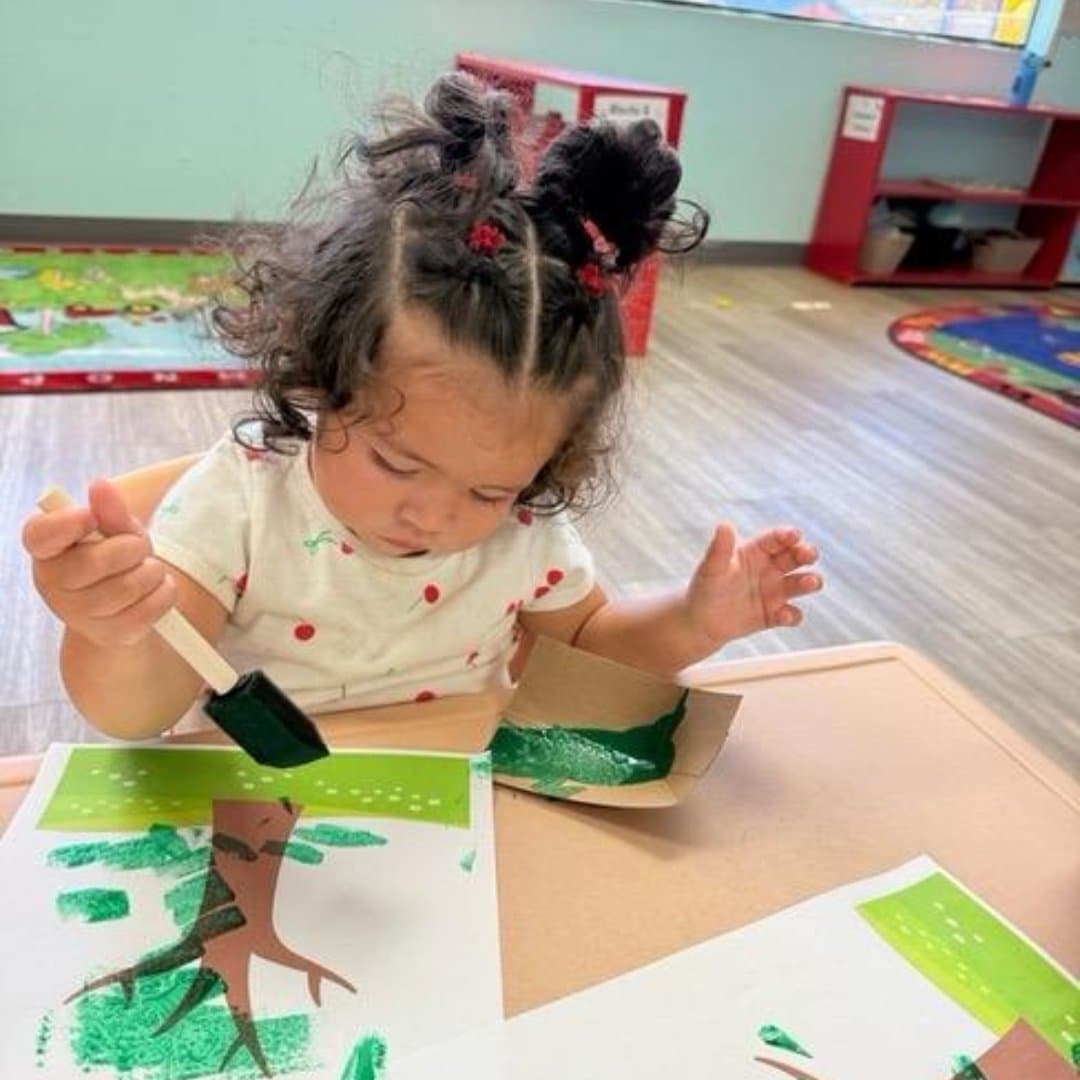 Student painting a tree craft project