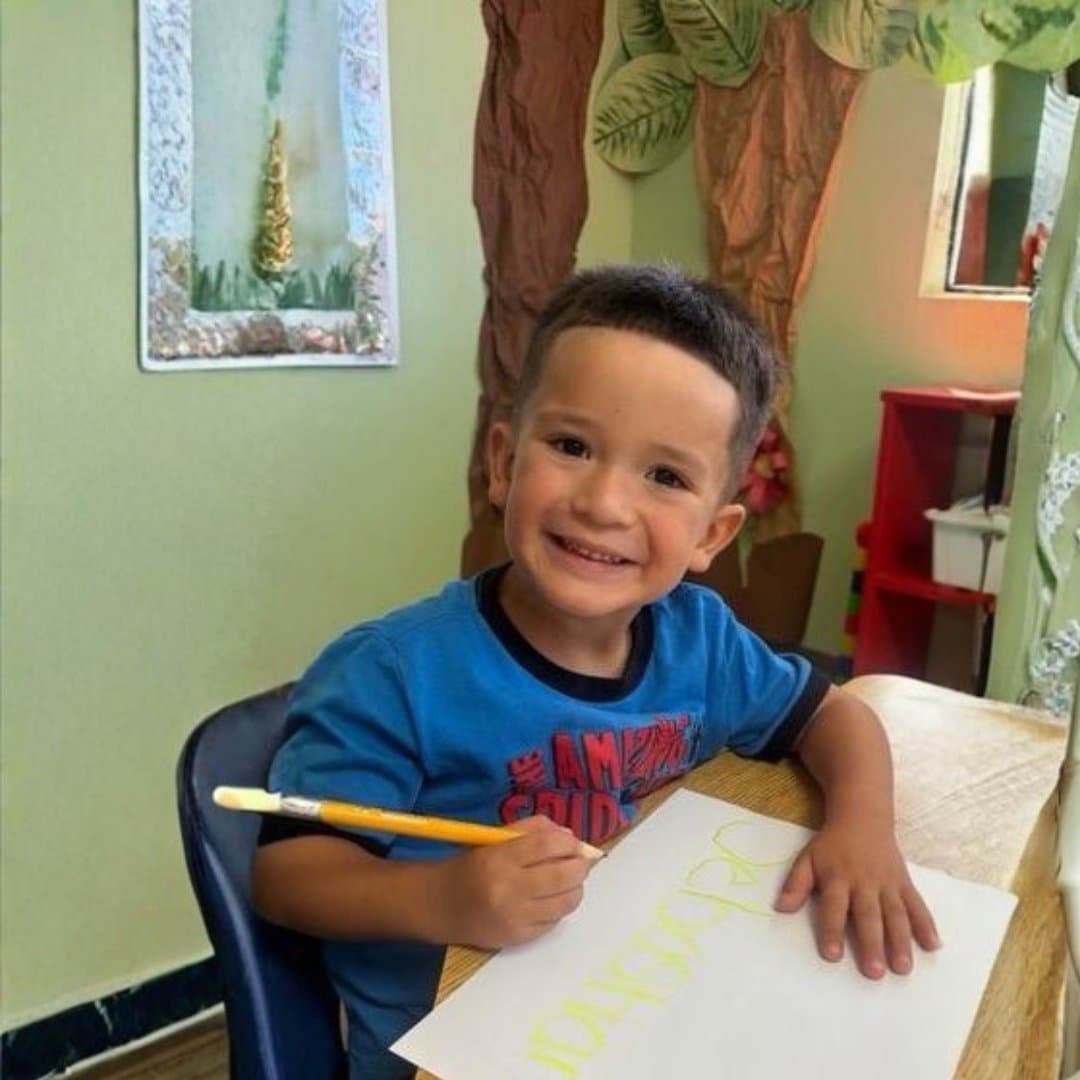 Student practicing handwriting at his desk