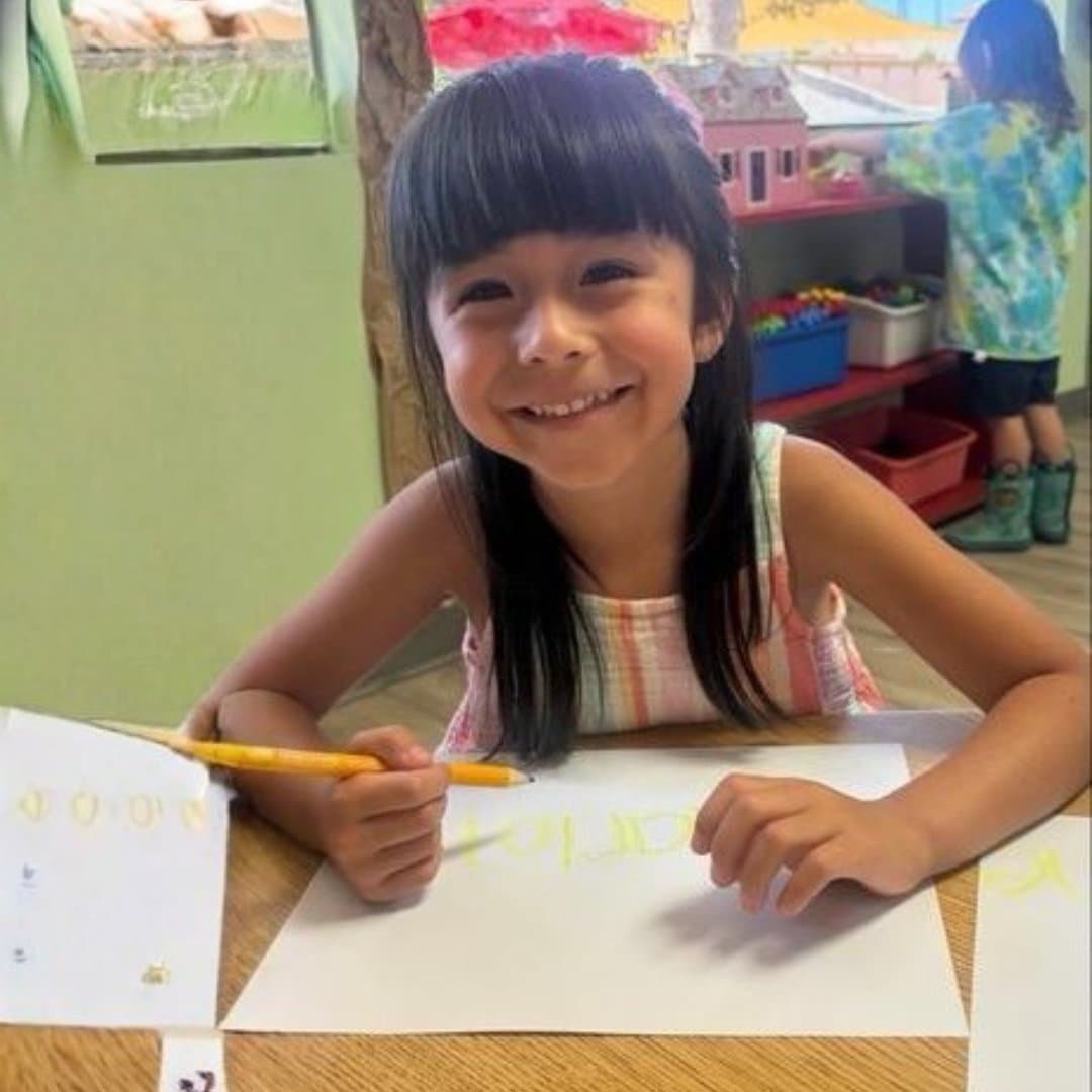 Student practicing handwriting at her desk