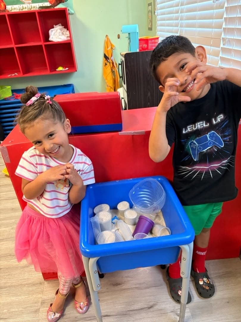 Preschoolers enjoying sensory bin play