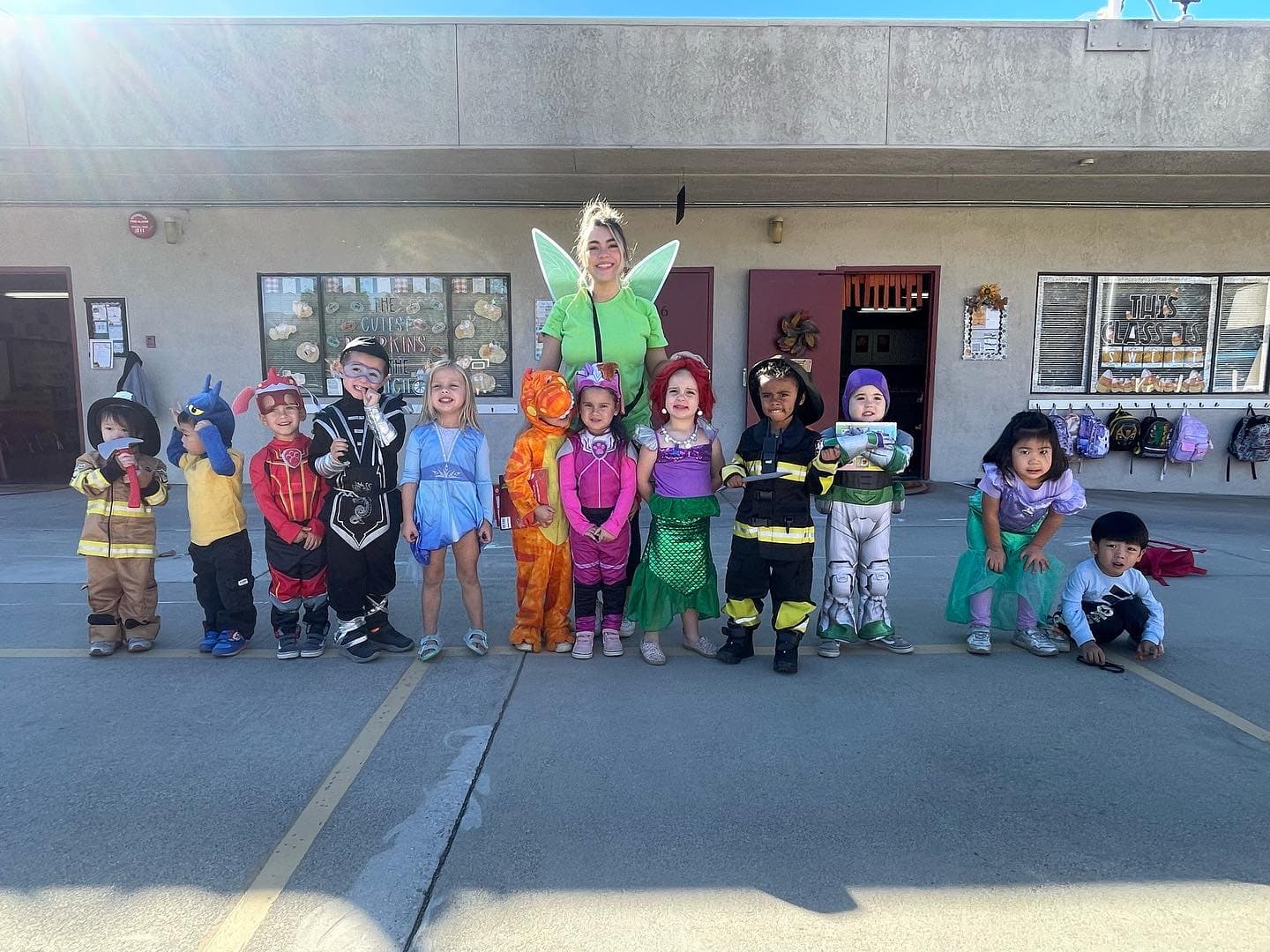 Students and staff at Little Explorers Academy celebrating together in costume outside the campus