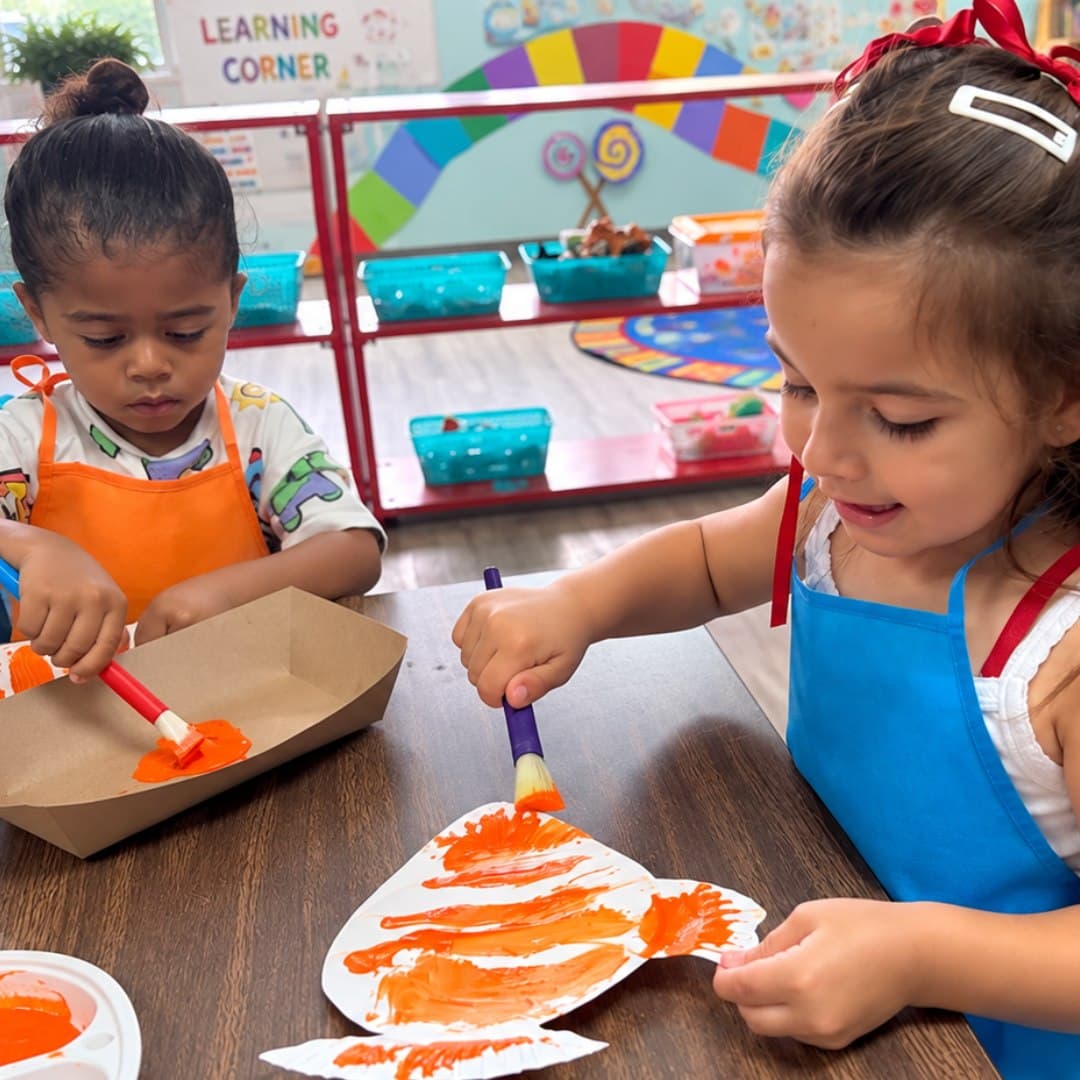 Preschoolers painting a fish art project